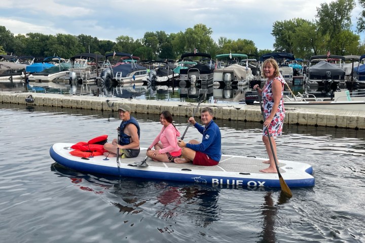 a group of people riding on the back of a boat in the water