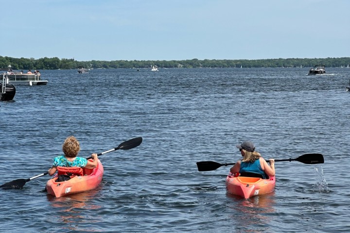 a group of people rowing a boat in a body of water