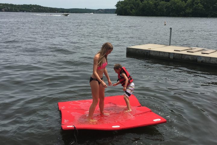 a person riding a surf board on a body of water