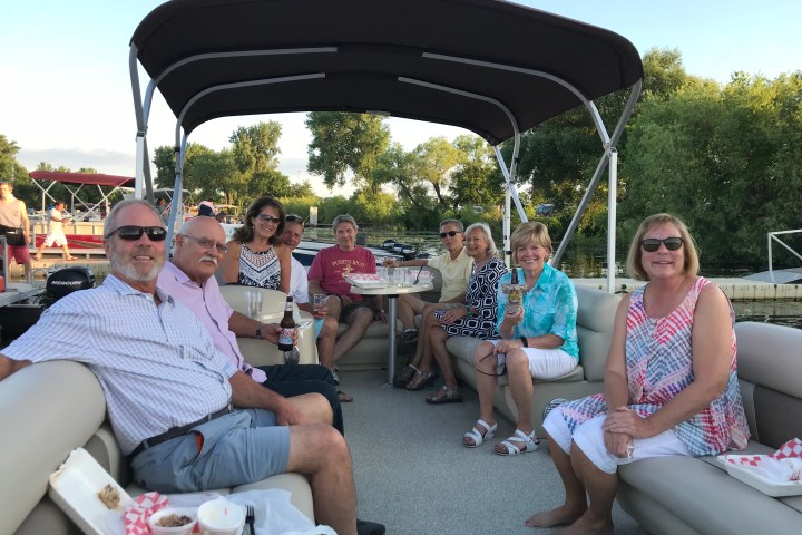 Group of people sitting on pontoon boat