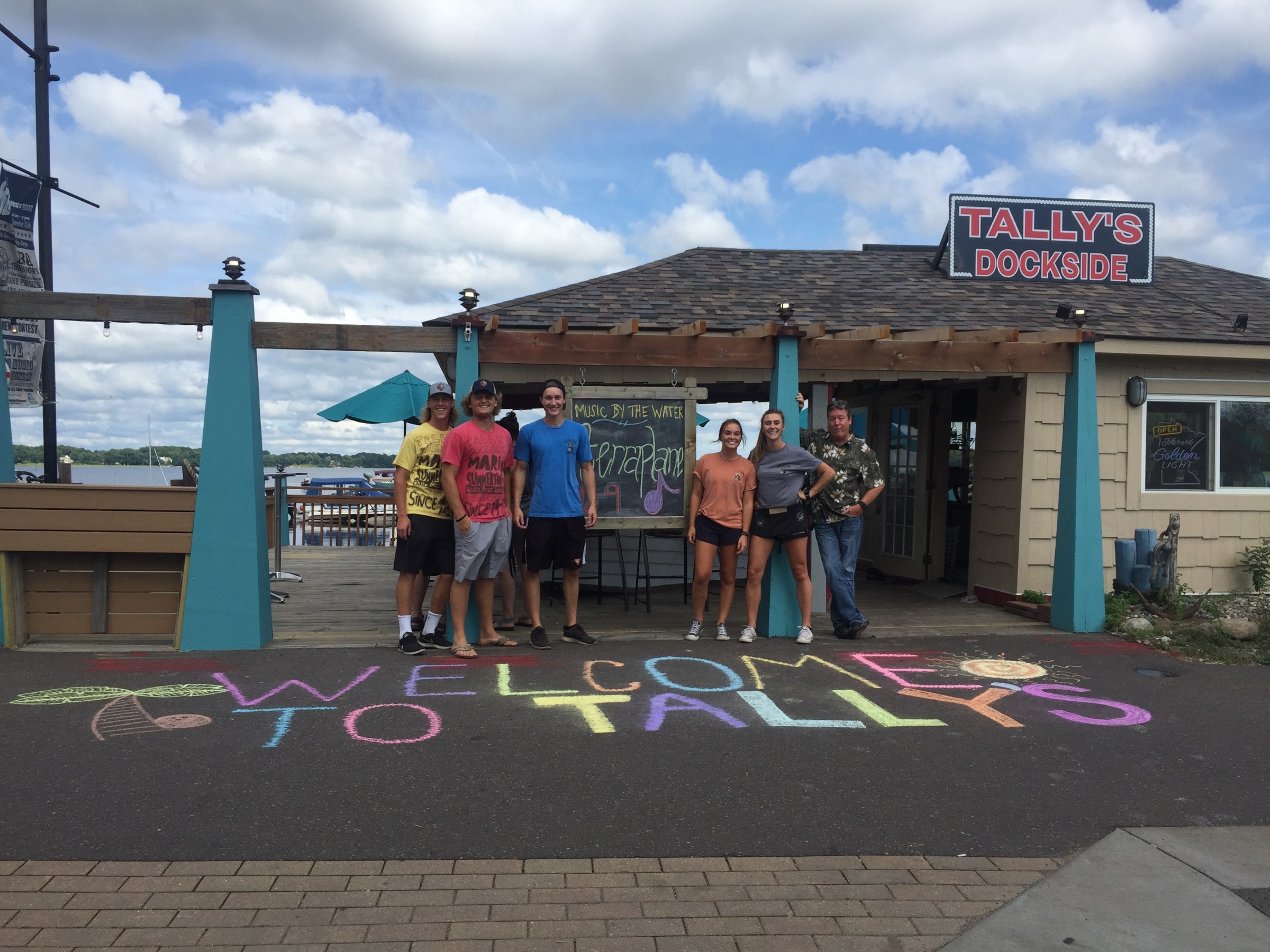group of Tally's Dockside staff standing outside of Tally's main building