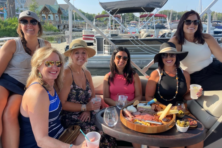 a group of people sitting on a boat posing for the camera