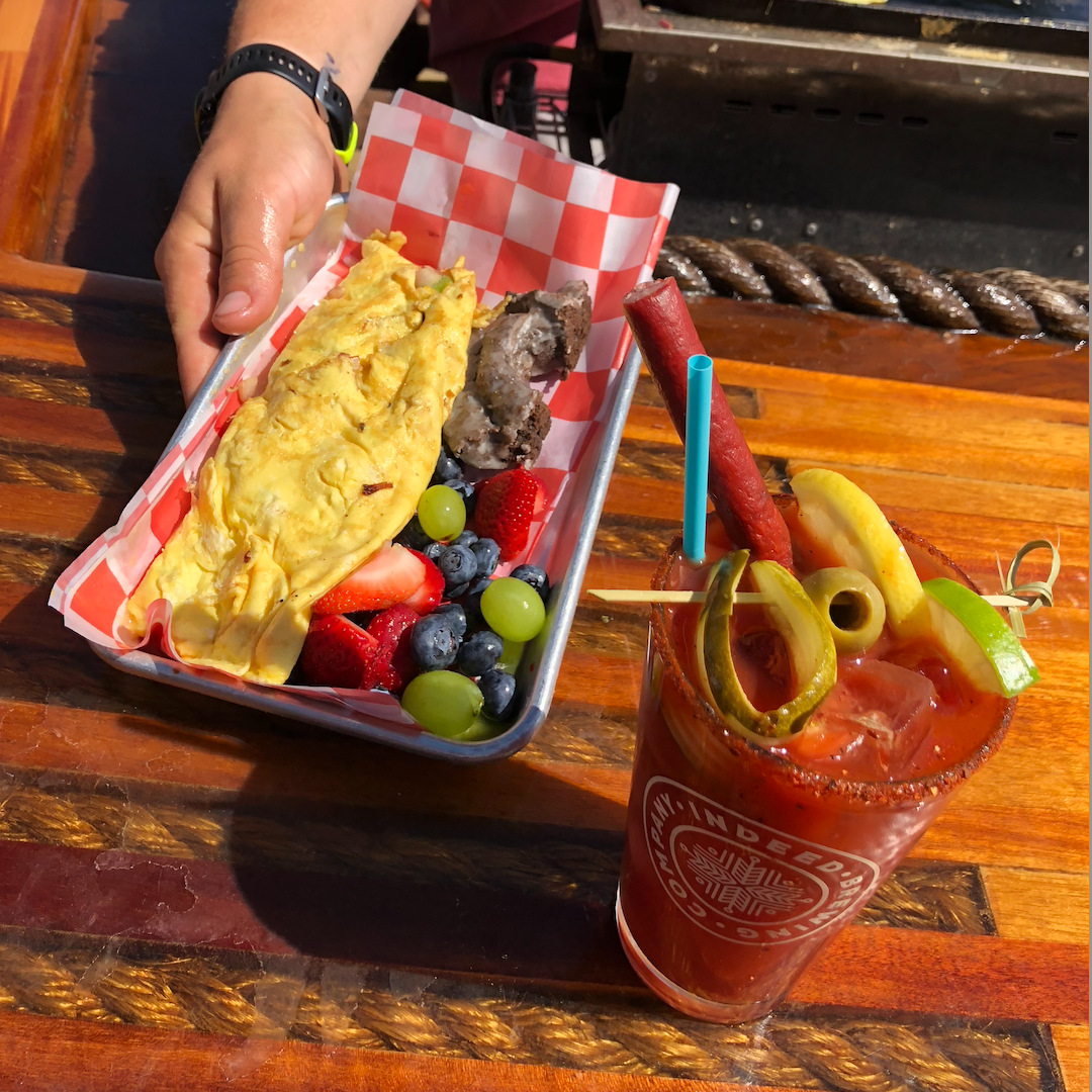a person sitting at a table with a plate of food