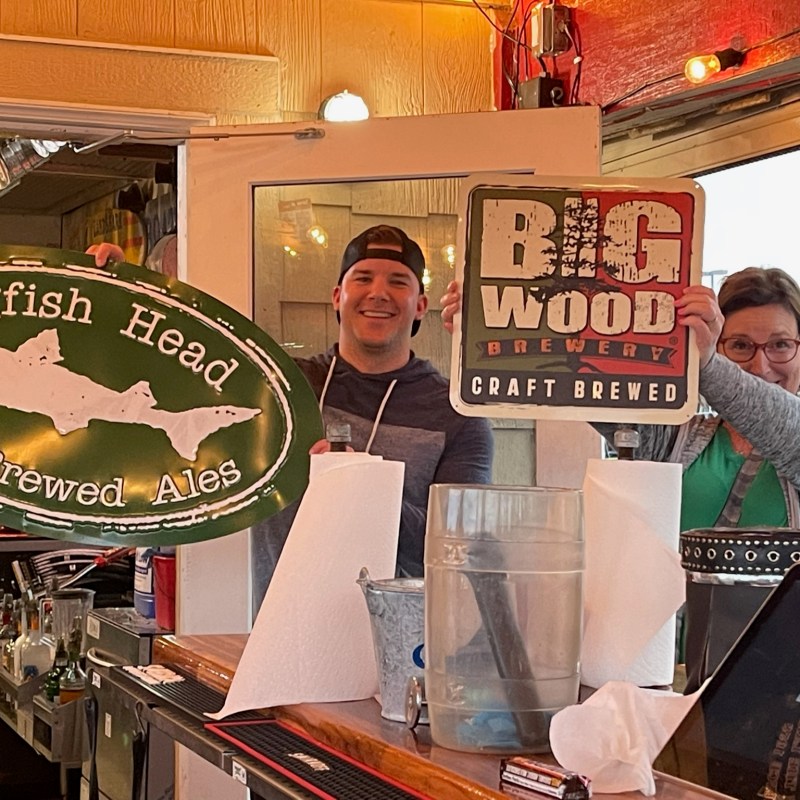 a person sitting at a table in front of a store