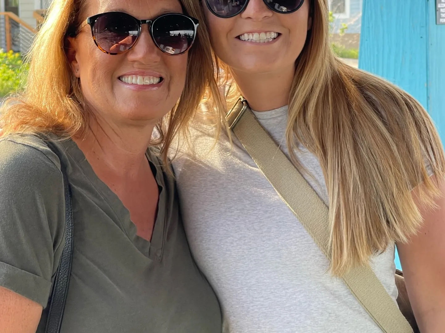 a woman wearing sunglasses posing for the camera